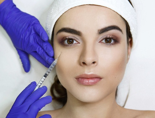 Cosmetologiest makes beauty injection in woman's face in the clinic